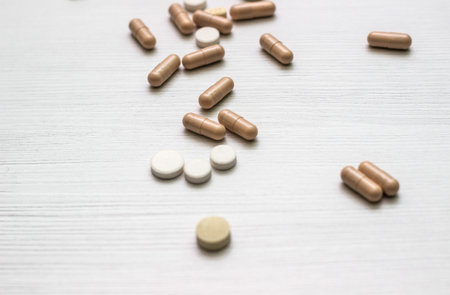 Alternative medicine herbal treatment concept. Medications, tablets and pill bottles with herbの写真素材