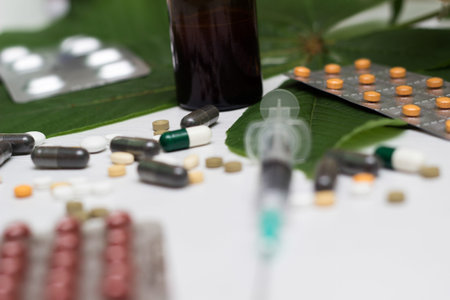 Medications, tablets and pill bottles with green herb