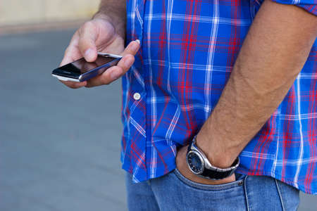 Close up of a young man using smart phoneの写真素材