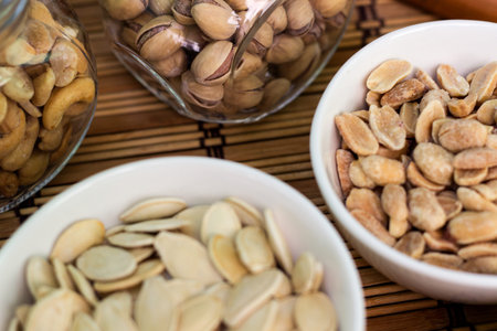 Granola Bars and mixed nuts. Honey bars with peanuts, chocolate, dried fruit, sesame and sunflower seedsの写真素材