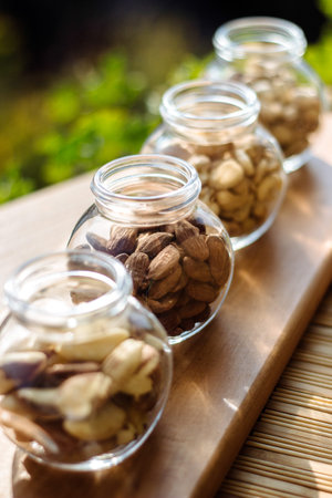 Nuts and seeds. Superfoods in Bowls on Wooden Background