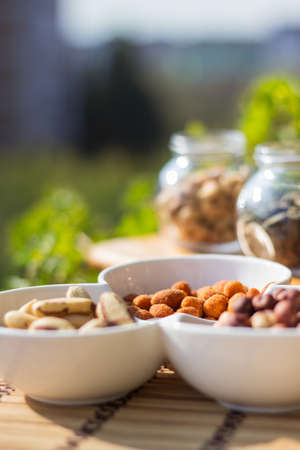 Nuts and seeds. Superfoods in Bowls on Wooden Backgroundの写真素材