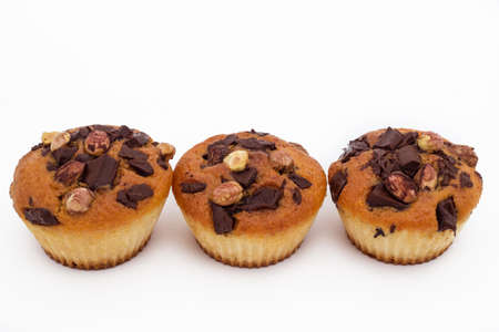 Delicious muffins with chocolate and hazelnut, isolated on whiteの写真素材