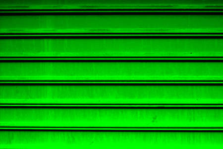 Green metal shutter door background. Green garage gate, metal material, steelの写真素材