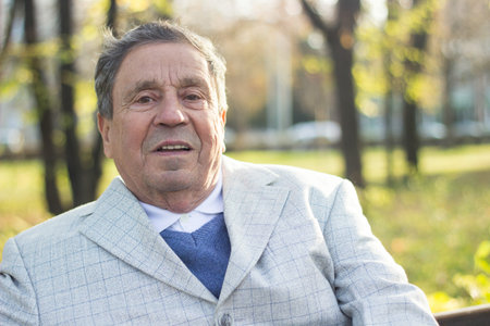Portrait of a smiling senior man in Nature, looking away