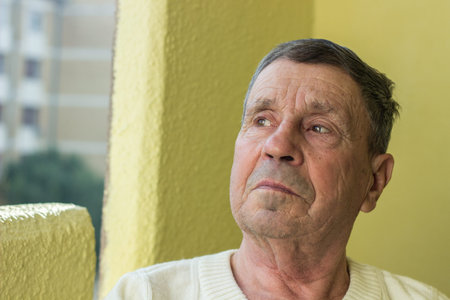 Pensive senior man looking down. Feeling bad, sadness