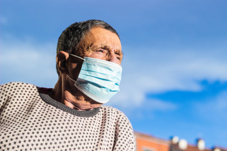 Portrait of a senior man wearing a protective face mask. Health safety conceptの写真素材
