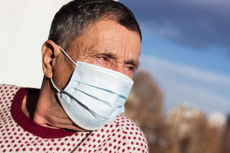 Portrait of a senior man wearing a protective face mask. Health safety conceptの写真素材