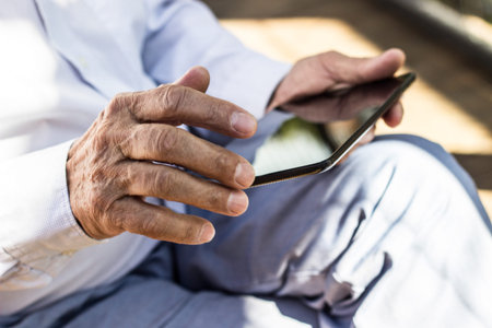 Senior man operating a tablet PC. Chatting on digital tablet, reading news on digital tablet,...