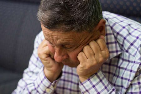 Portrait of elderly man lost in thoughtの写真素材