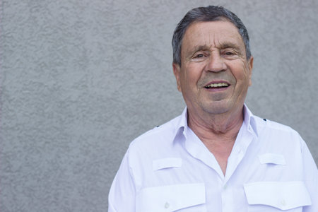 Portrait of a smiling senior man feeling great, looking at camera