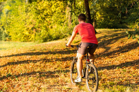 Young man riding bike in nature