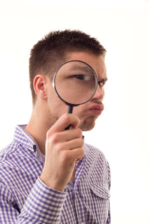 Angry man through Magnifying glassの写真素材