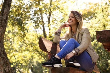 Autumn photo of a beautiful woman. Enjoying in the city park. Nature. Outdoorsの写真素材