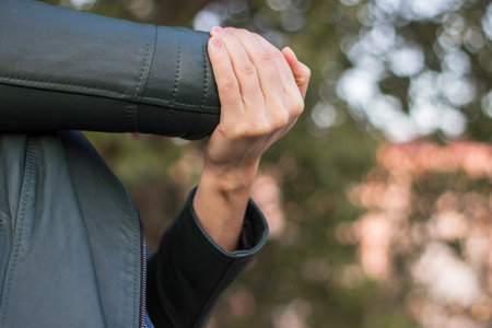 Young woman with Elbow pain, bokeh backgroundの写真素材