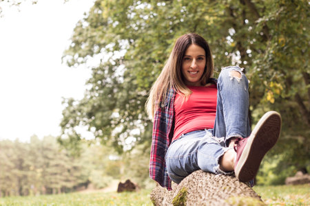 Portrait of a very happy woman at the park and enjoying natureの写真素材