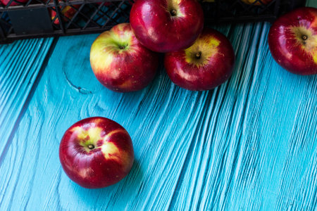 Red apples in wooden wicker basket. Freshly picked applesの写真素材