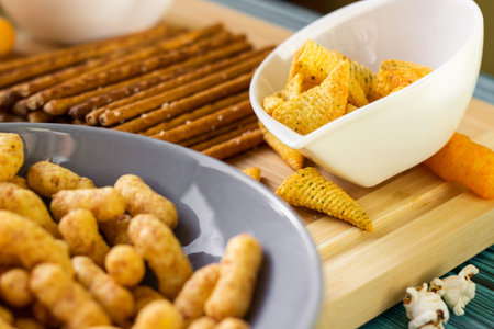 Beer salty snacks on wooden table
