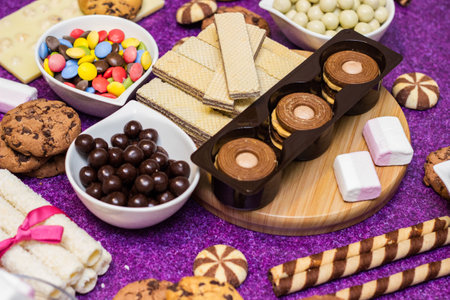 Chocolate and biscuits background. Chocolate and biscuits background. Many pieces of chocolate, candies, cookies, biscuits, cakes, donuts, and other sweets. Milk chocolate and darkの素材 [FY310193454680]