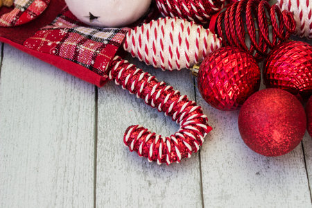 Christmas red decorations are sticking out of the Christmas stocking. Red and white ornaments, and...