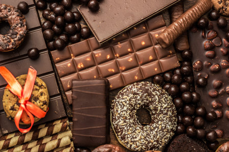 Dark and milk chocolate products and biscuits. Chocolate assortment background