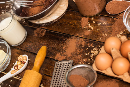 Cake baking ingredients. Ingredients for cooking chocolate pastry from above on wooden backgroundの写真素材