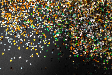 Multicolored glitter background for Christmas and other celebrations. Black background. For variety of topics like Christmas, luxury, success, celebrationの写真素材