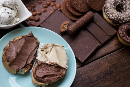 Chocolate cream on a bread and colorful sweets and candies