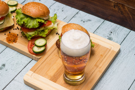 Burgers and beer on wooden backgroundの写真素材