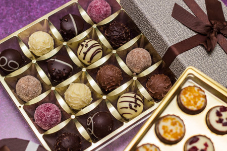 Box with delicious chocolate candies and heart shape gift