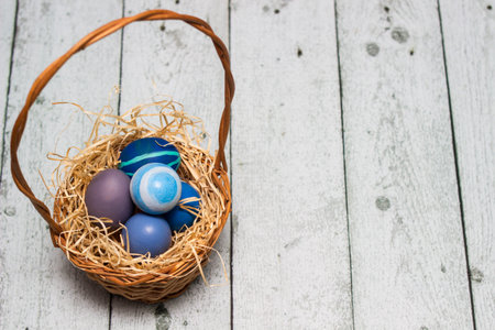 Painted blue easter eggs in a basket
