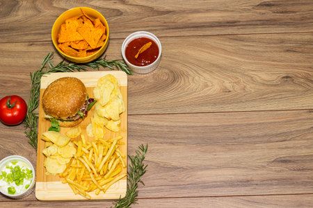 Pizza and Hamburger on wooden background with French friesの写真素材
