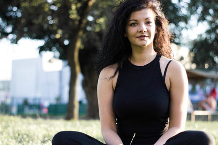 Beautiful cheerful young woman outdoors, portraitの写真素材