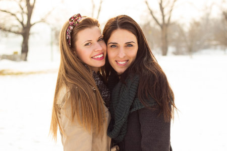 Portrait of two beautiful women, winter, snowの写真素材