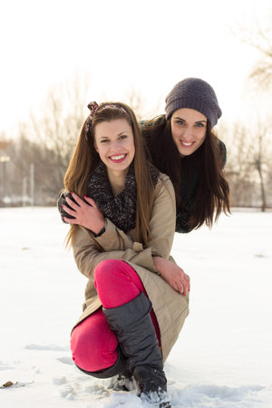 Portrait of two beautiful women, winter, snowの写真素材
