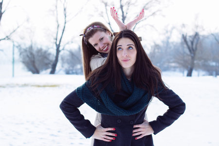 Portrait of two beautiful women, winter, snow