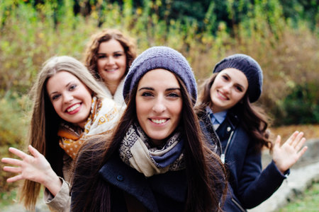 Portrait of four attractive young women, smiling and laughingの写真素材