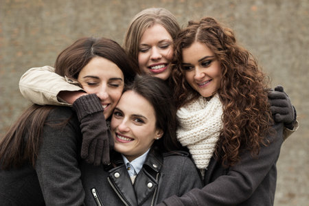 Portrait of four attractive young women, smiling and laughingの写真素材