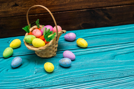 Easter eggs in basket  on empty wooden tableの写真素材