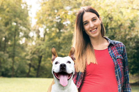 Smiling young attractive woman portrait with her cute dogの写真素材