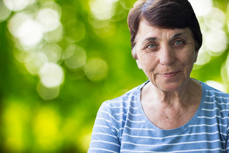 Senior woman's radiant smile amidst Nature's Serenityの写真素材