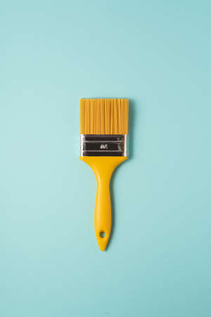 Abstract pasta composition. Creative layout made of paint brush and spaghetti on blue background. Flat lay, top view.の写真素材
