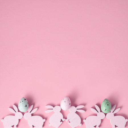 Easter composition made with Easter bunnies and eggs on bright pink background. Minimal creative holiday concept.の写真素材
