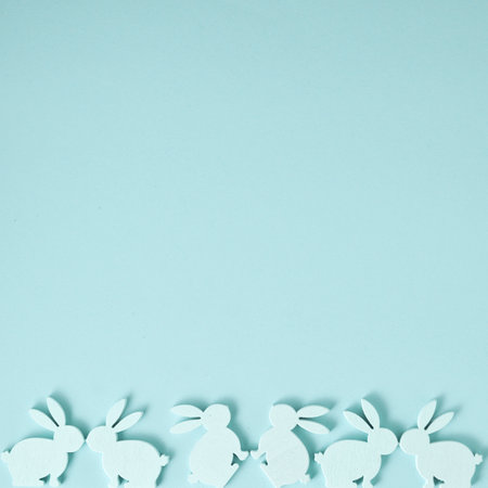 Easter composition made with Easter bunnies on bright blue background. Monochromatic creative holiday concept.の写真素材