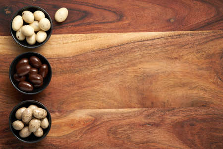 Chocolate Easter eggs on wooden background. Rustic composition. Copy space, space for text.の写真素材