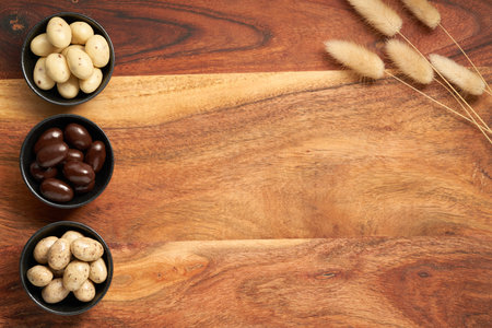 Chocolate Easter eggs on wooden background. Rustic composition. Copy space, space for text.の写真素材