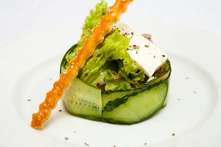 Salad with cucumber greens and a stickの写真素材