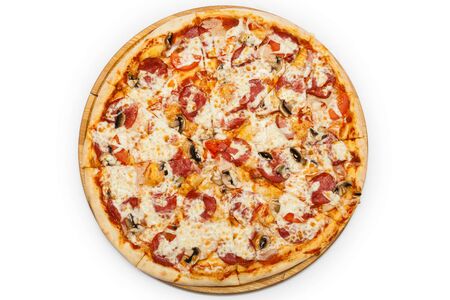 Tasty pizza with vegetables and arugula on cutting board isolated on whiteの写真素材