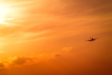The plane is in the sky, the plane is landing. Plane in the westの写真素材