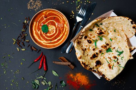 Indian food on a dark background, in paper utensils, photos for menus and advertising. Additives and spicy spices.の写真素材